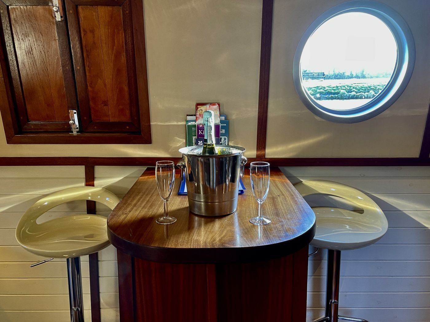 Curved breakfast bar beside a porthole