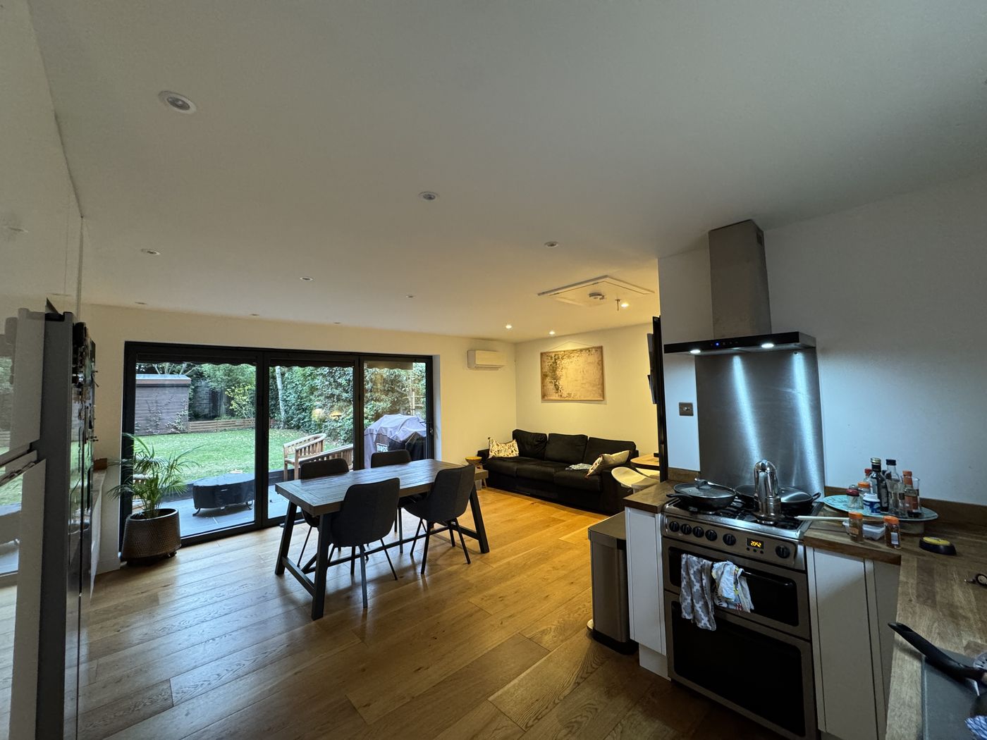 Open-plan living area looking out to the garden through sliding doors